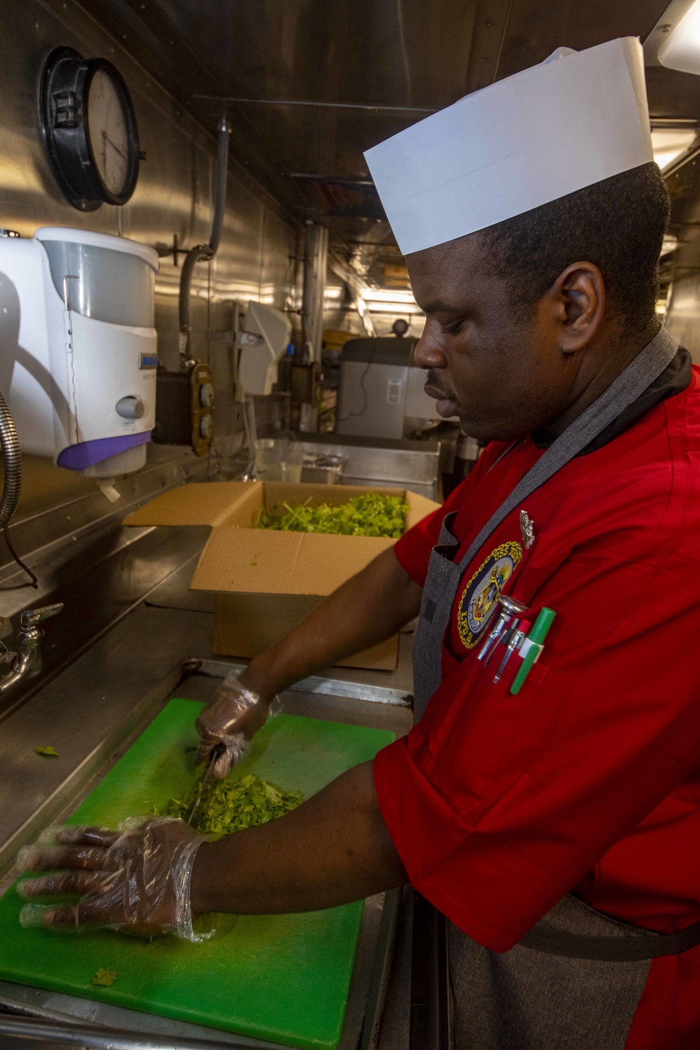 Sailors work in the galley