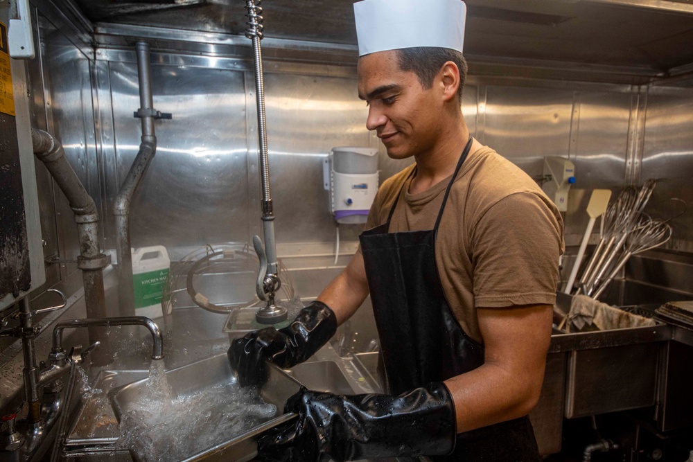 Sailors work in the galley