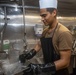 Sailors work in the galley