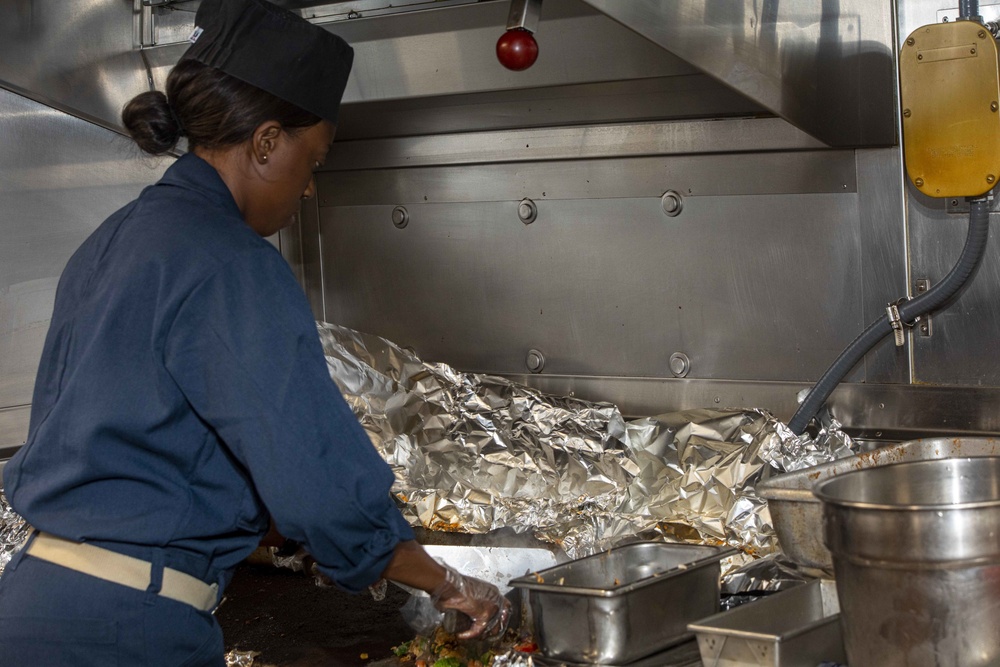 Sailors work in the galley