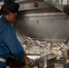 Sailors work in the galley