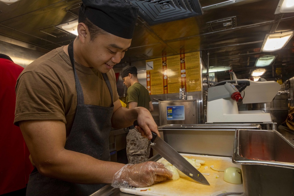 Sailors work in the galley