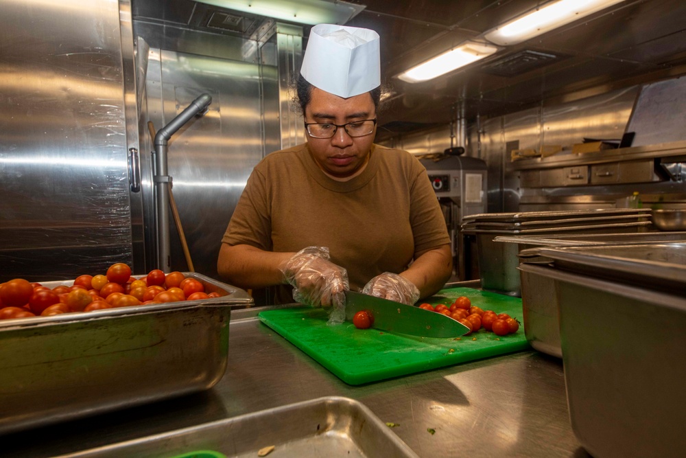 Sailors work in the galley