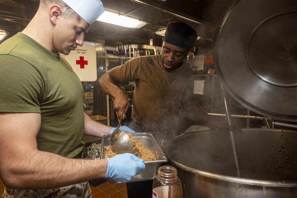 Sailors work in the galley