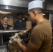 Sailors work in the galley