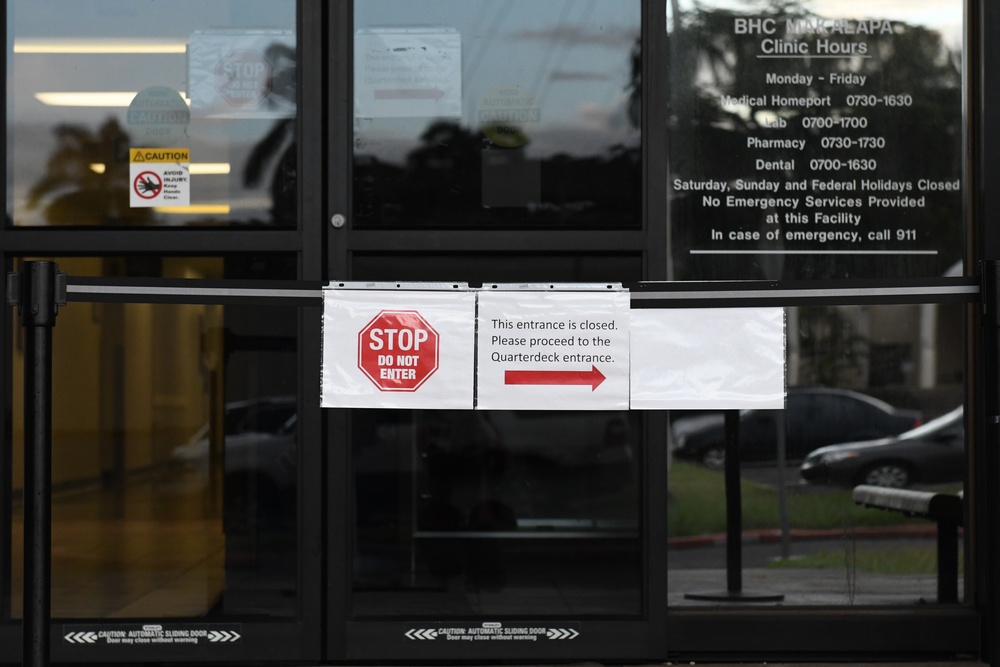 Signs posted outside secured entrances to BHC Makalapa redirect patients