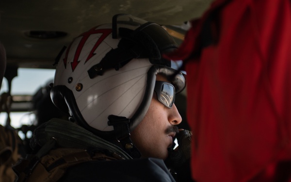 Naval Air Crewman prepares to take off from the flight deck of the aircraft carrier USS Gerald R. Ford