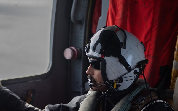 Naval Air Crewman observes flight operations