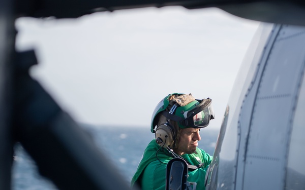 U.S. Navy Sailor performs maintenance on MH-60S Sea Hawk