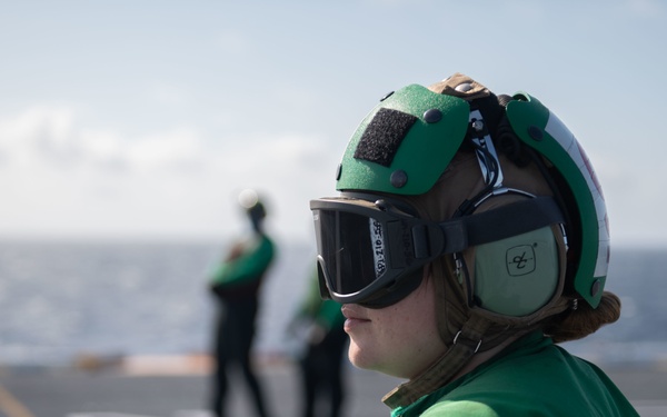 U.S. Navy Sailor observes flight operations on the flight deck of the air carrier USS Gerald R. Ford