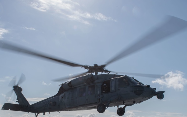 An MH-60S Sea Hawk lands on the flight deck of the aircraft carrier USS Gerald R. Ford