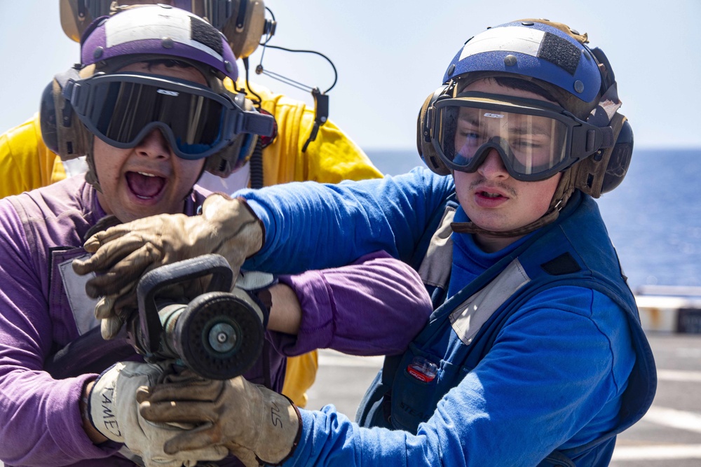 Sailors take part in flight deck fire fighting drills