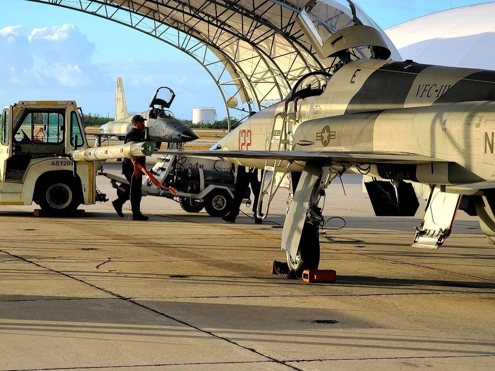 PAE employees conduct maintenance on a F-5N Tiger II