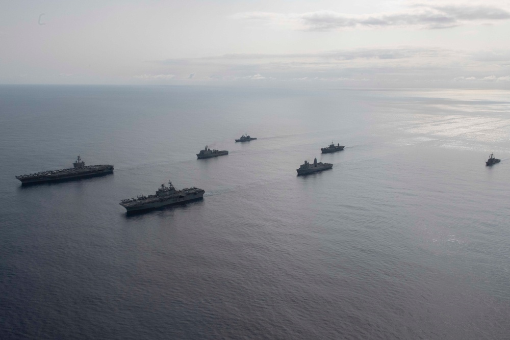 Ships from the Theodore Roosevelt Carrier Strike Group, the America Expeditionary Strike Group, and the U.S. 7th Fleet command ship, USS Blue Ridge (LCC 19) transit the Philippine Sea