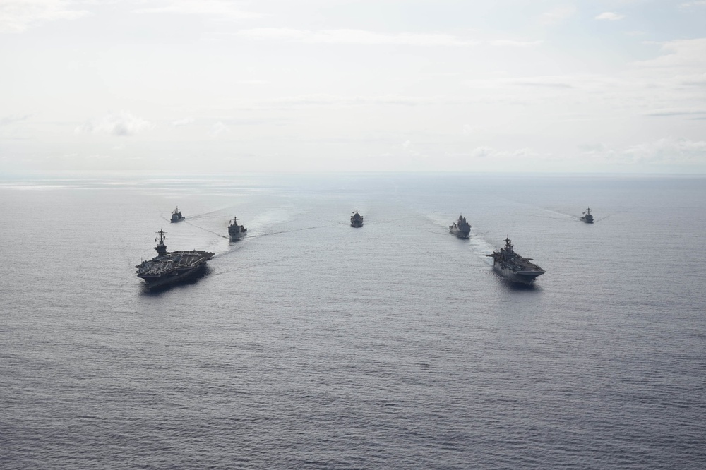 Ships from the Theodore Roosevelt Carrier Strike Group, the America Expeditionary Strike Group, and the U.S. 7th Fleet command ship, USS Blue Ridge (LCC 19), transit the Philippine Sea
