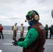 U.S. Sailor prepares to launch an MH-60S Sea Hawk