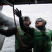 U.S. Sailors perform engine water-wash on MH-60S Sea Hawk