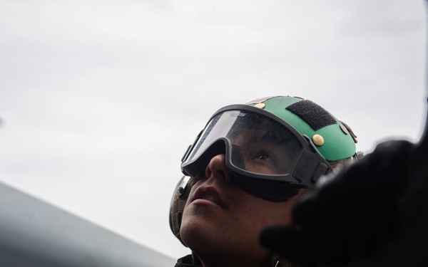 U.S. Sailor performs maintenance on MH-60S Sea Hawk