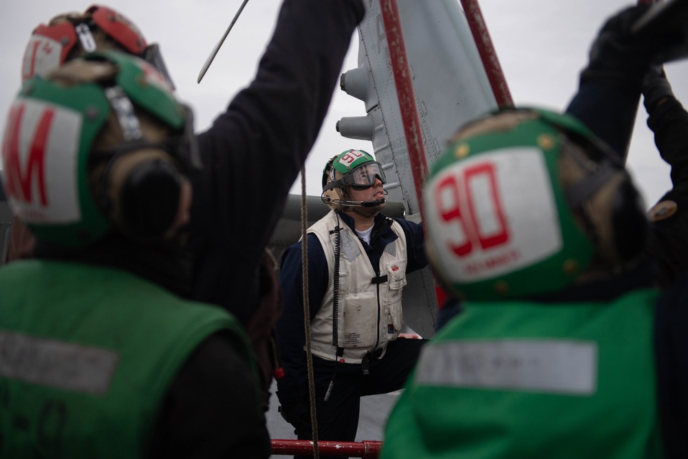 U.S. Sailor observes shut-down operations of MH-60S Sea Hawk