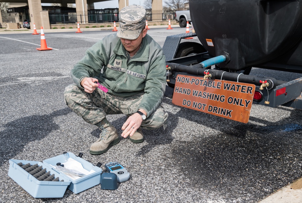 Dover Air Force Base Medical and Security Forces Airmen conduct medical screenings to mitigate COVID-19 spread