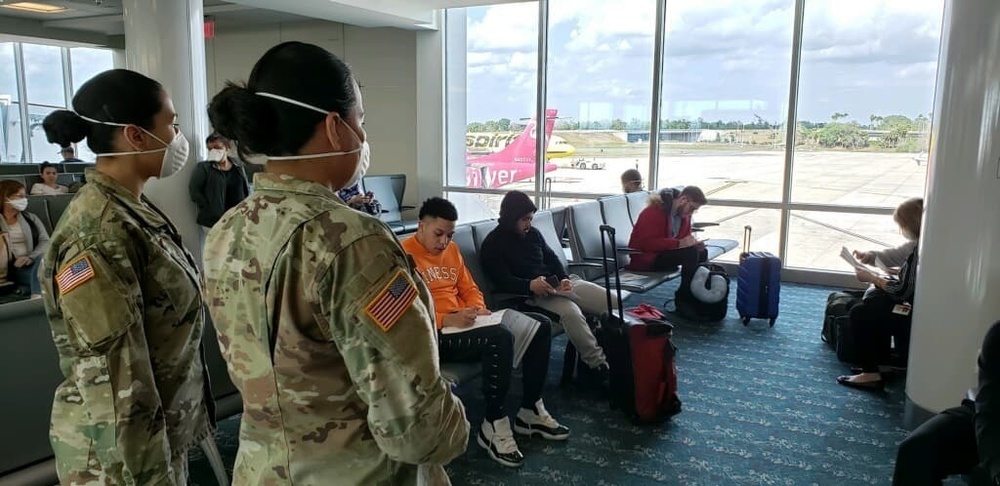 Florida Department of Health and Florida National Guard Soldiers work together at Orlando International Airport.