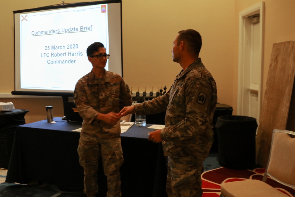 Soldier receives ceremonial coin for outstanding work on first day of operations