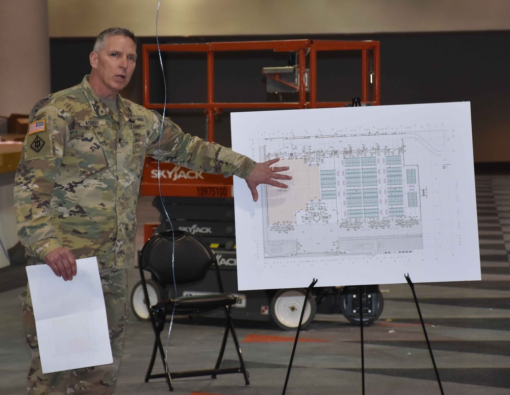 Col. Thomas Asbery, Commander, New York District, shows points on a floor layout of the USACE constructed Alternate Care Facility at Jacob Javits Center.