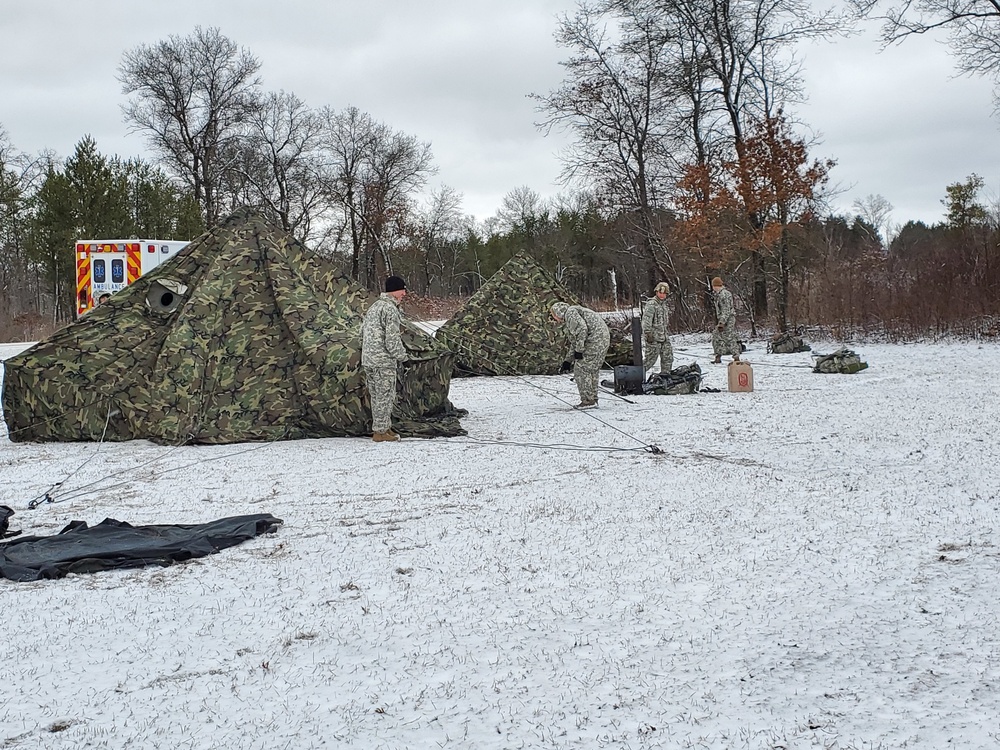 Cold-Weather Operations Course Class 20-05 students build Arctic 10-person tents