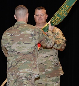Garrison Commander passes the colors to Command Sgt. Maj. Fogle