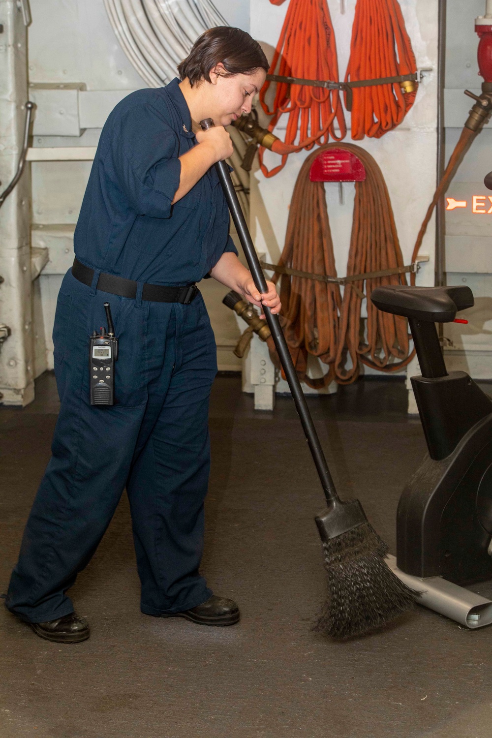 Sailor and Marines clean the ship