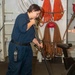 Sailor and Marines clean the ship