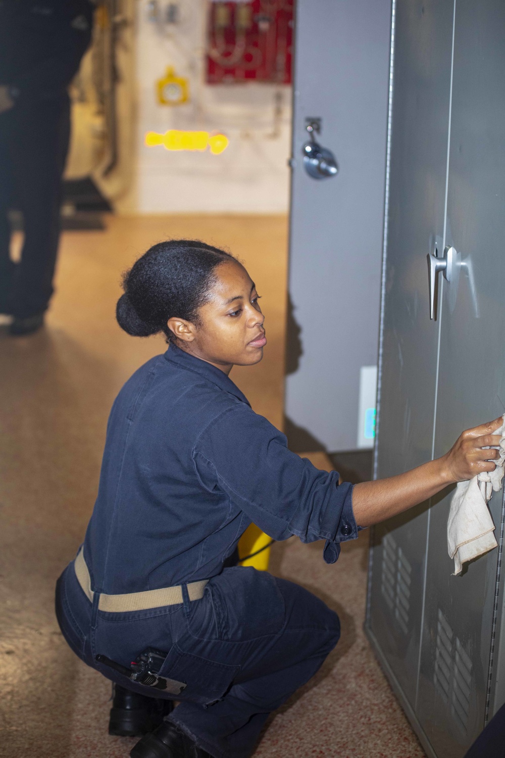 Sailor and Marines clean the ship