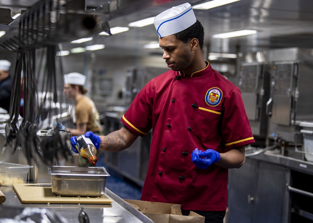 USNS Mercy Sailor Prepares Meal