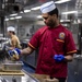 USNS Mercy Sailor Prepares Meal