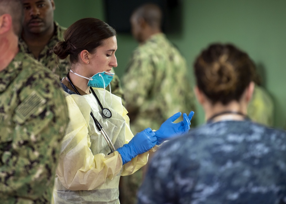 USNS Mercy Sailor Dons Surgical Gloves