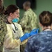 USNS Mercy Sailor Dons Surgical Gloves