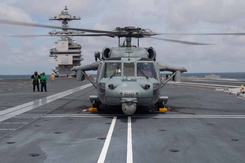 An MH-60S Sea Hawk prepares to take off from the flight deck of the USS Gerald R. Ford