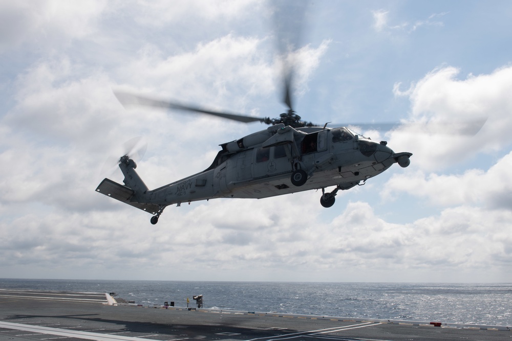 MH-60S Sea Hawk takes off from the flight deck of the aircraft carrier USS Gerald R. Ford