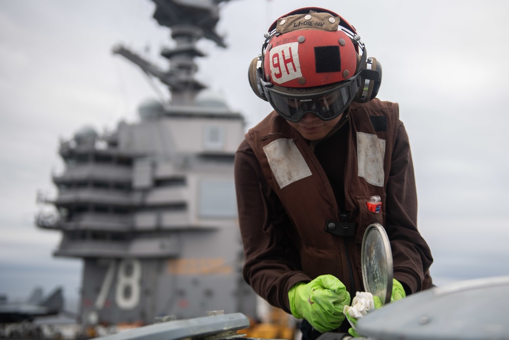 U.S. Sailor does maintenance on an MH-60S Sea Hawk