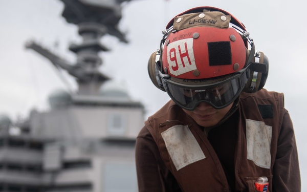 U.S. Sailor does maintenance on an MH-60S Sea Hawk