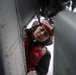 U.S. Sailor performs maintenance on an MH-60S Sea Hawk