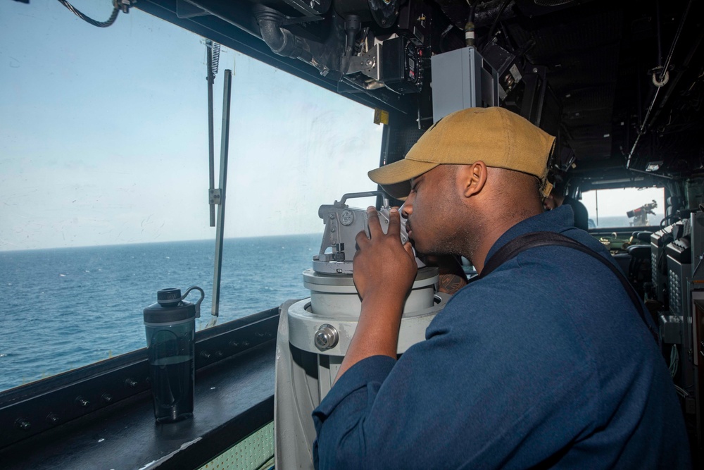 Sailor stands watch on the bridge