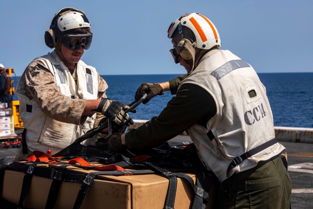 Sailors and Marines take part in a replenishment-at-sea