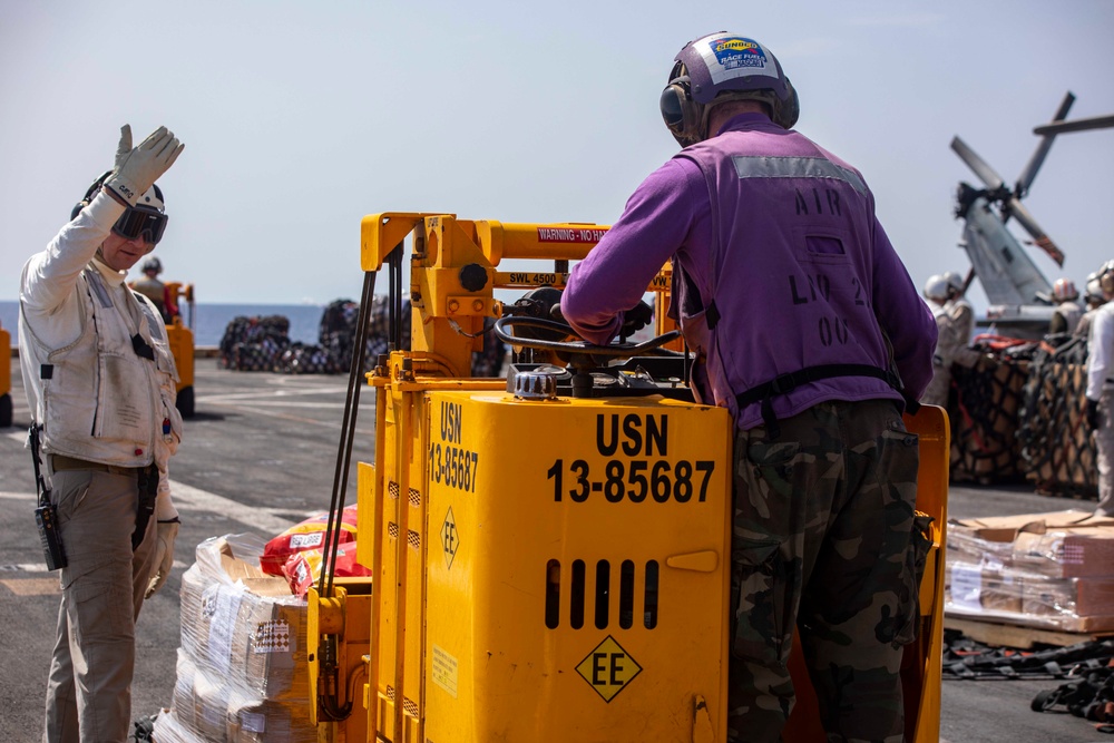 Sailors and Marines take part in a replenishment-at-sea