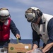 Sailors and Marines take part in a replenishment-at-sea