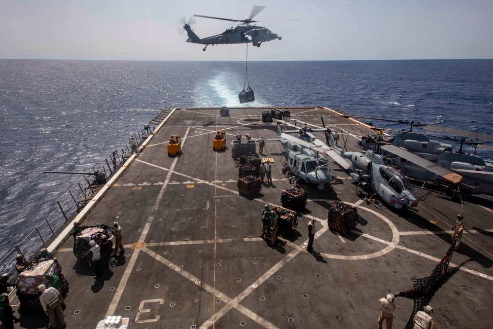 Sailors and Marines take part in a replenishment-at-sea