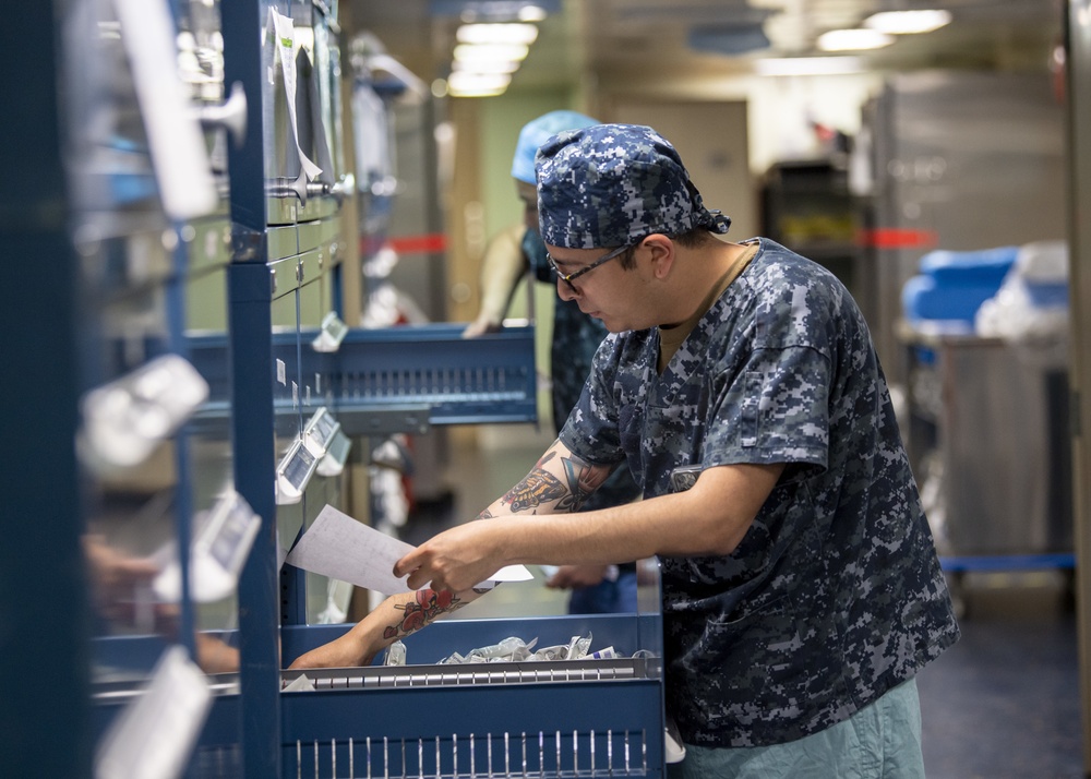 USNS Mercy Sailor Checks Medical Supply Inventory