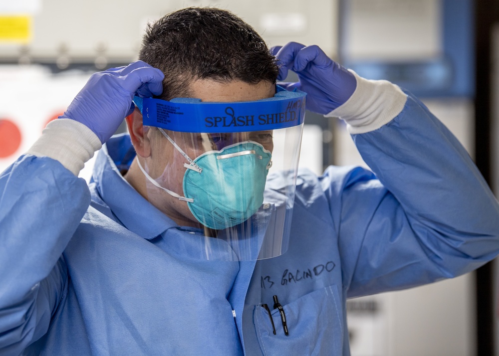 USNS Mercy Sailor Dons Splash Shield