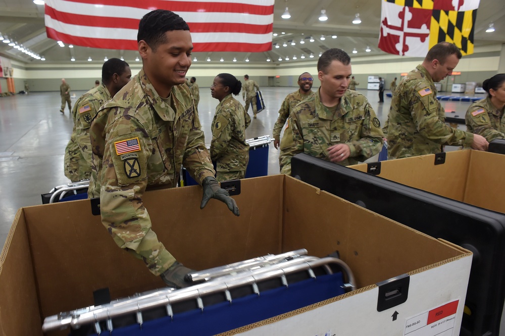 Maryland Army National Guard Guard members set up auxiliary medical station, prep for COVID-19 patients