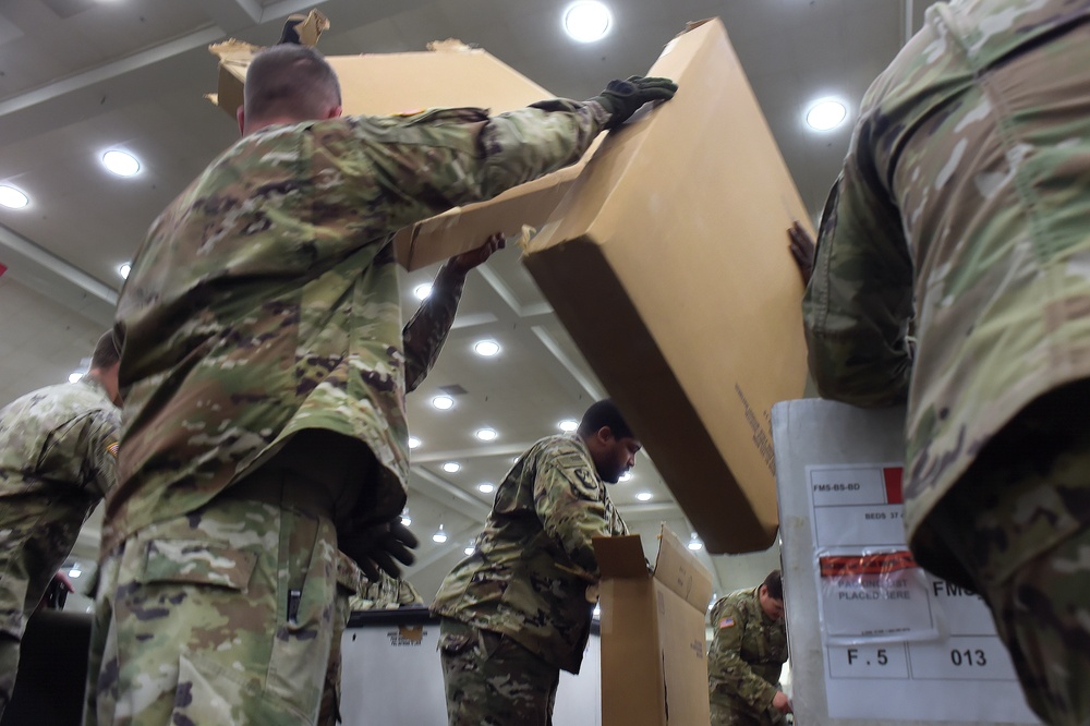 Maryland Army National Guard Guard members set up auxiliary medical station, prep for COVID-19 patients